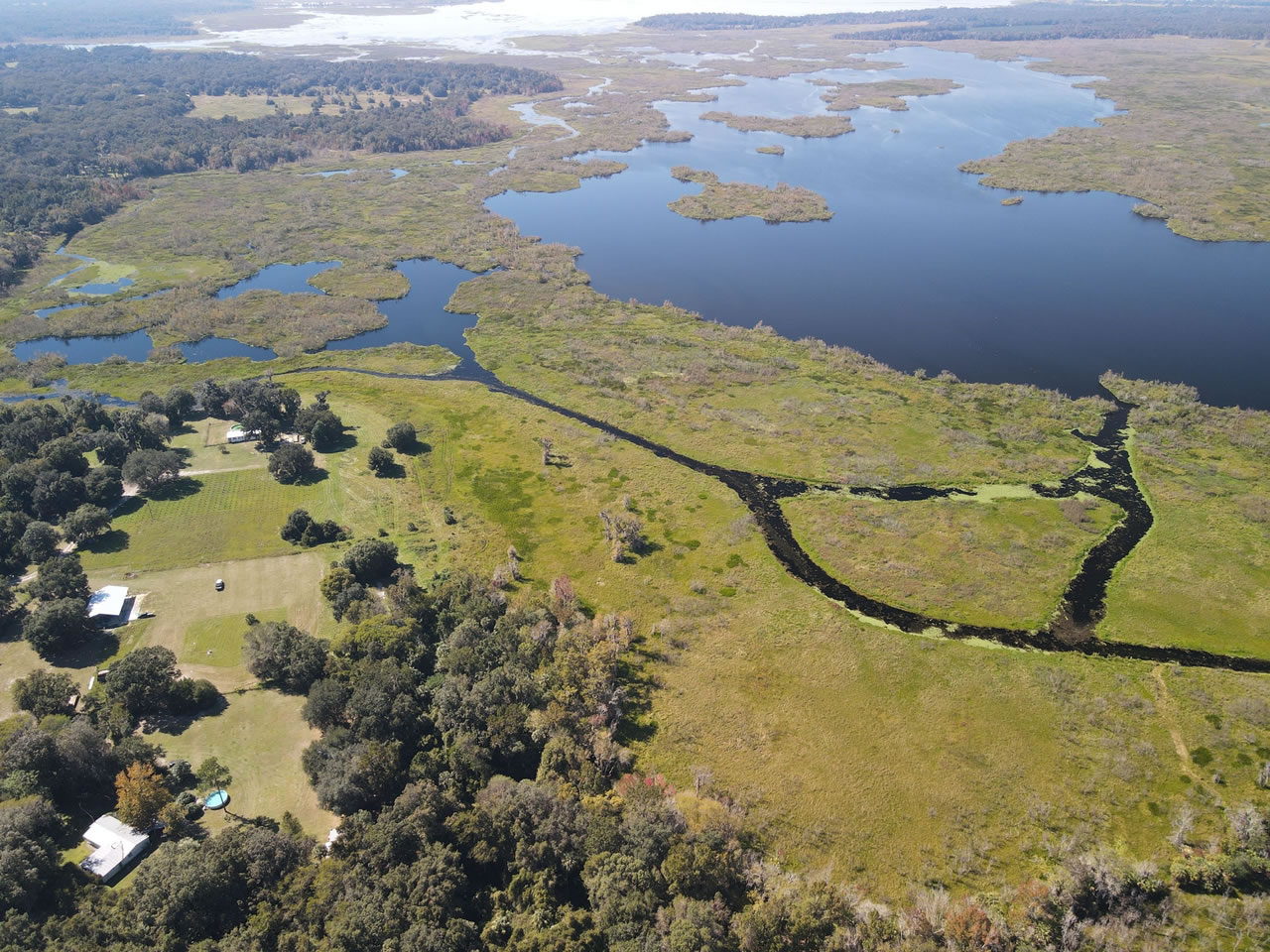 Drone Shot of Orange Lake Behind Park